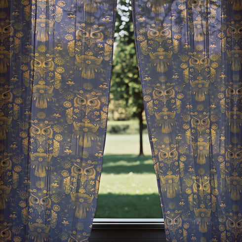 A sheer curtain panel featuring a repeating pattern of ornate golden owls surrounded by delicate floral designs and botanical elements on a deep navy background. The fabric has a fine linen-like texture with translucent qualities.